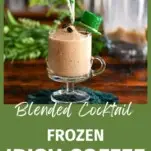 tan cocktail in footed glass mug, this Frozen Irish Coffee has St Patrick's Day straws, hat and greenery behind