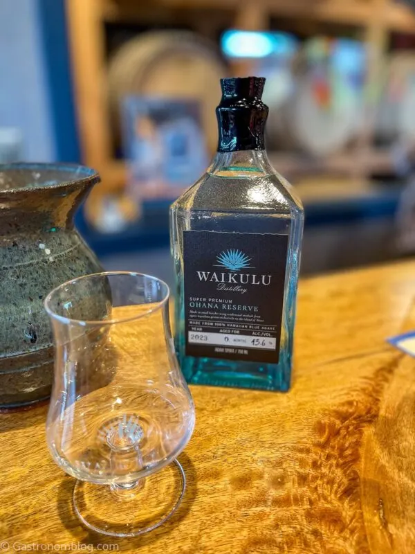 agave spirits tasting in glass and blue glass bottle at Waikulu Distillery on Maui