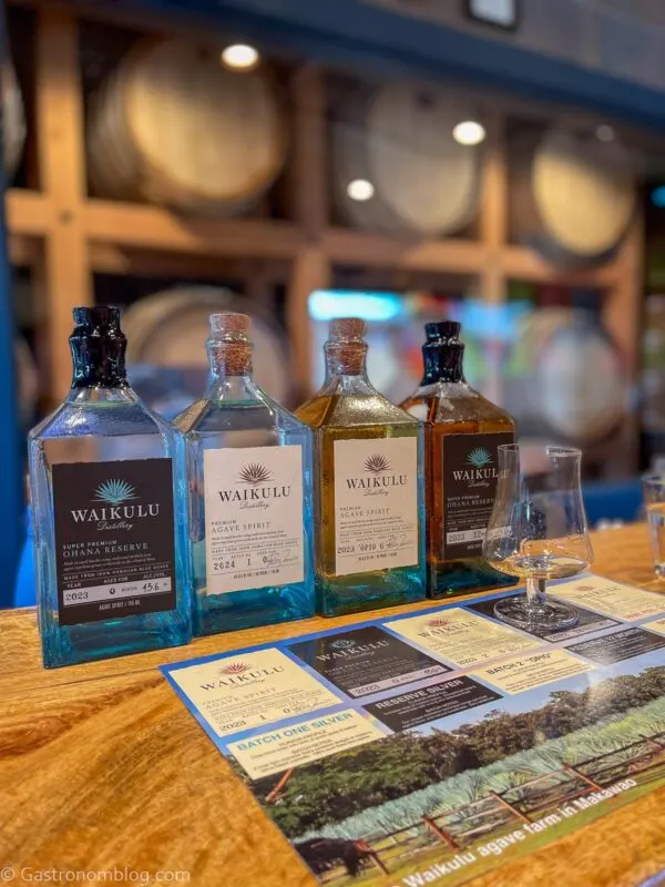 blue bottles in a row on bar at Waikulu Distillery on Maui