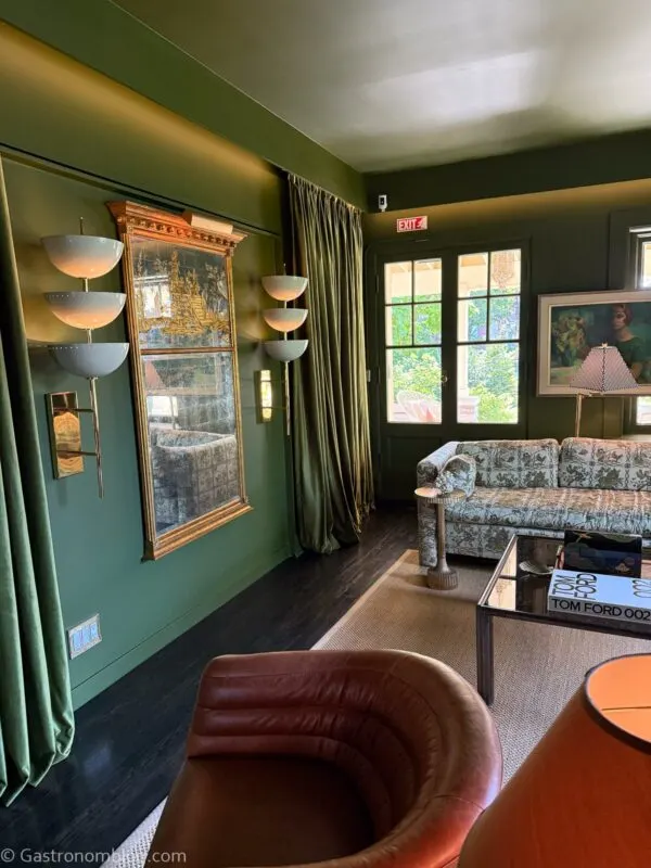 sitting room with green walls and gold touches, leather chairs at Aida Hotel Kansas City