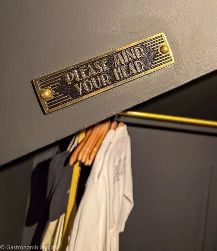 sign in bathroom "Please Watch Your Head" at Aida Hotel Kansas City