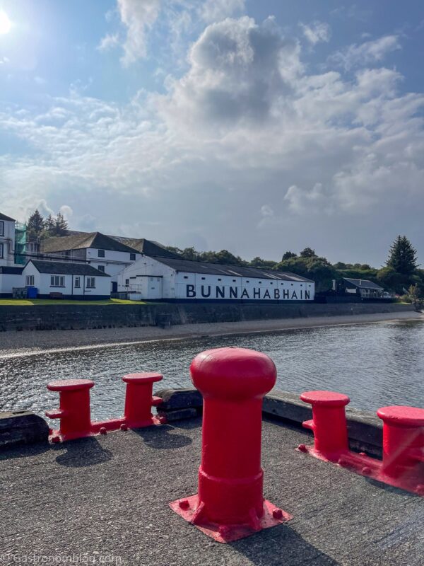 view of white buildings from pier at Bunnahabhain Distillery Tour