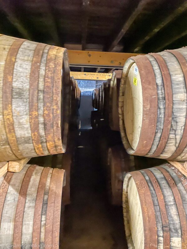 whisky casks in rows and stacked seen during Bunnahabhain Distillery tour