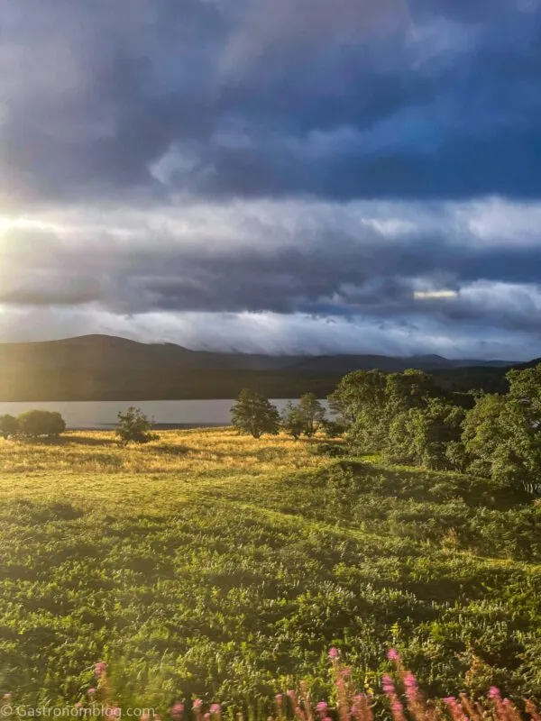 highlands with stream from train car on Caledonian Sleeper Train