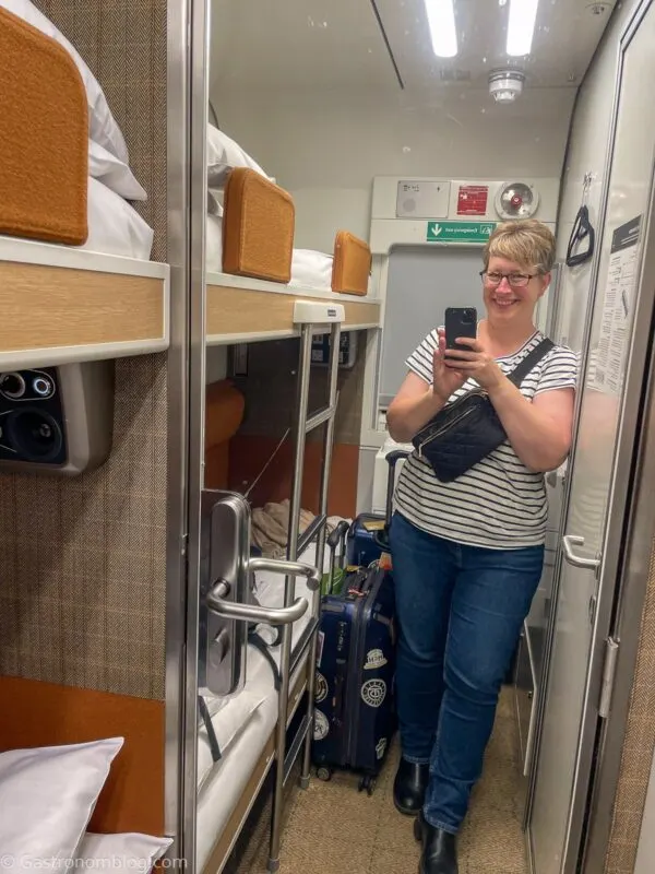 lady taking picture in mirror in cabin on Caledonian Sleeper Train