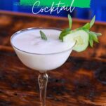 yellow cocktail glass with white yogurt cocktail and cucumber and mint garnish