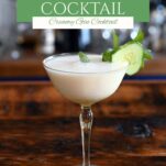 yellow cocktail glass with white yogurt cocktail and cucumber and mint garnish