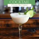yellow cocktail glass with white yogurt cocktail and cucumber and mint garnish