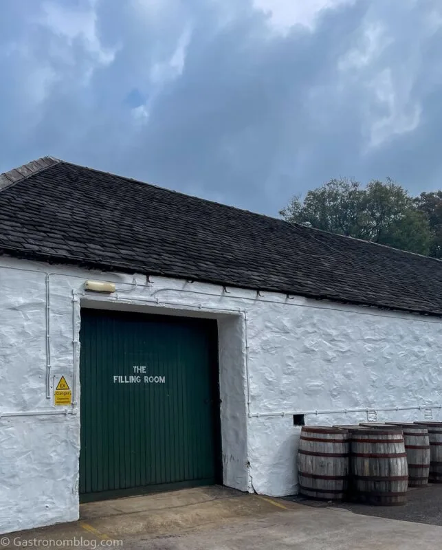 white warehouse with black door at Laphroaig Distillery