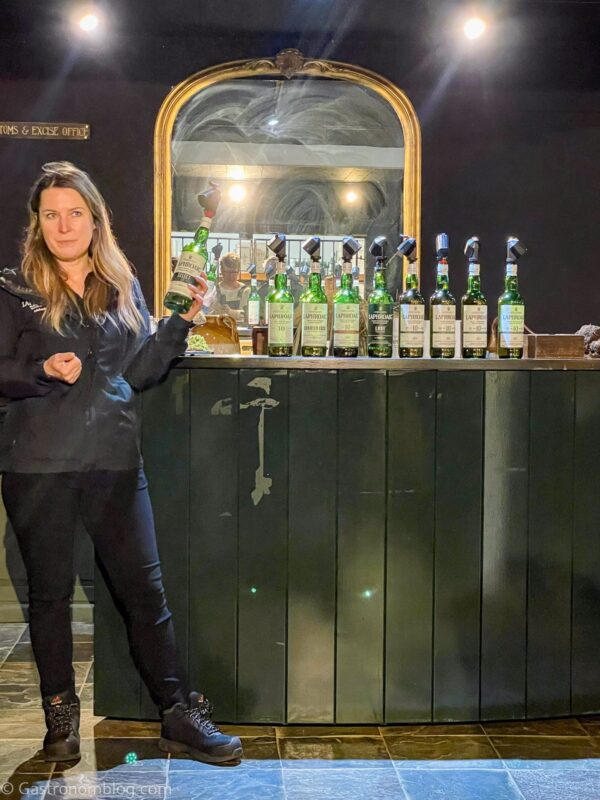 our tour guide with whisky tasting offerings at Laphroaig Distillery