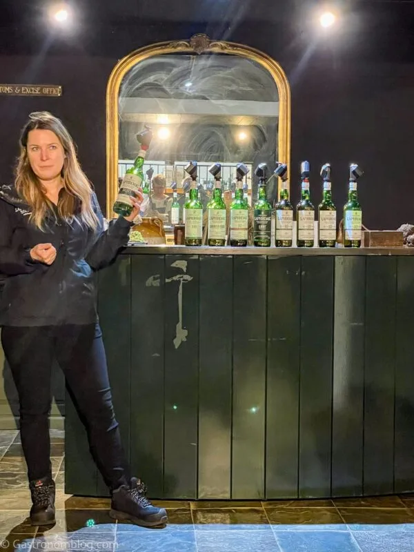 our tour guide with whisky tasting offerings at Laphroaig Distillery