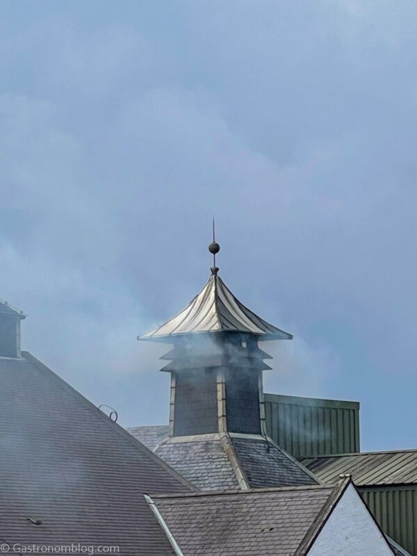 peat smoke coming out of chimney, blue sky behind