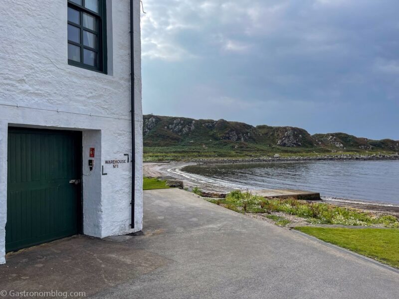 white building at Laphroaig Distillery, looking over the water on Islay
