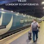 green Caledonian Sleeper Train in Eustan Train Station in London, lady walking with luggage
